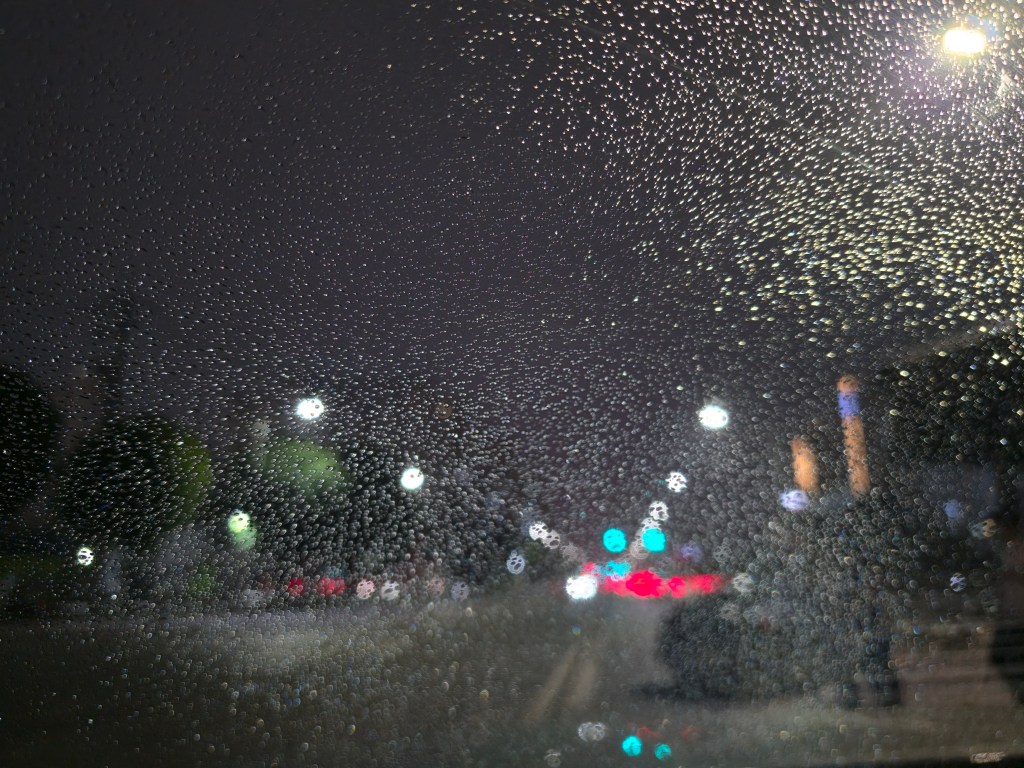 Raindrops on a car window before a rainy season run.